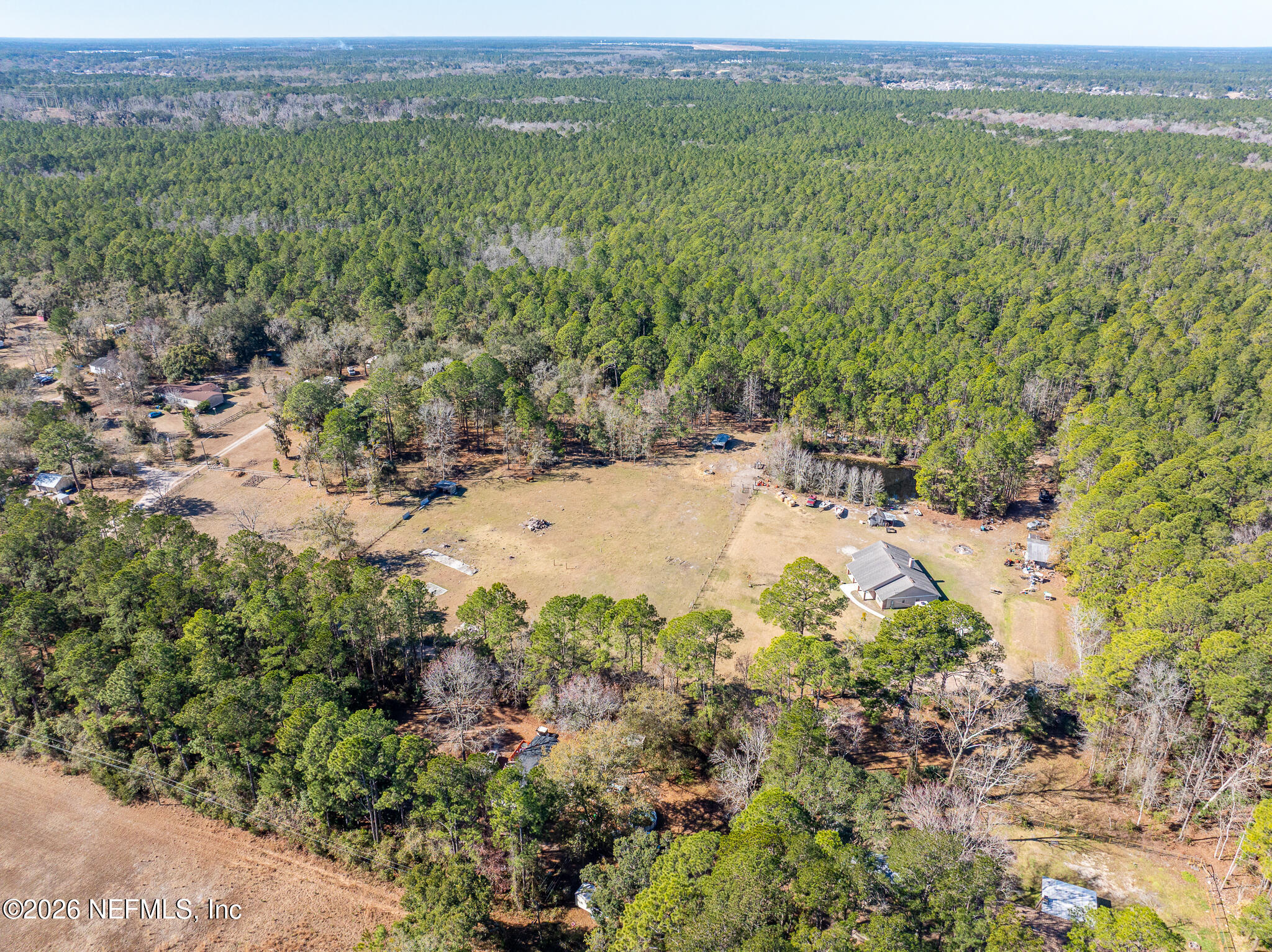 1725 Davidson Farm Road Jacksonville, FL 32218 - Photo 52 of 55 a view of a lush green field with lots of plants and trees in the background
