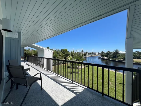 a view of a balcony with furniture