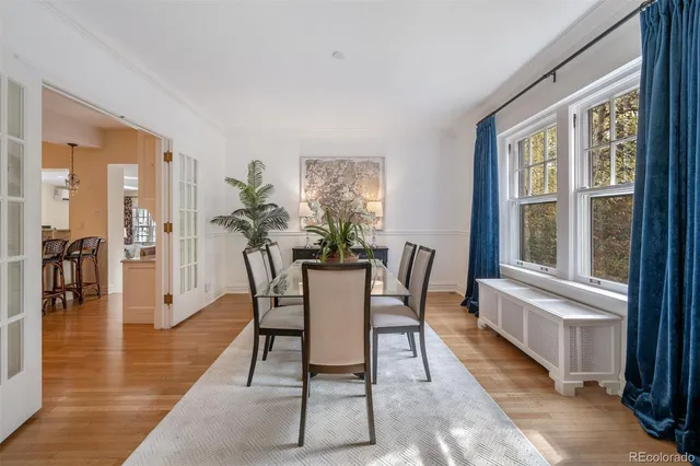 a dining room with furniture and wooden floor