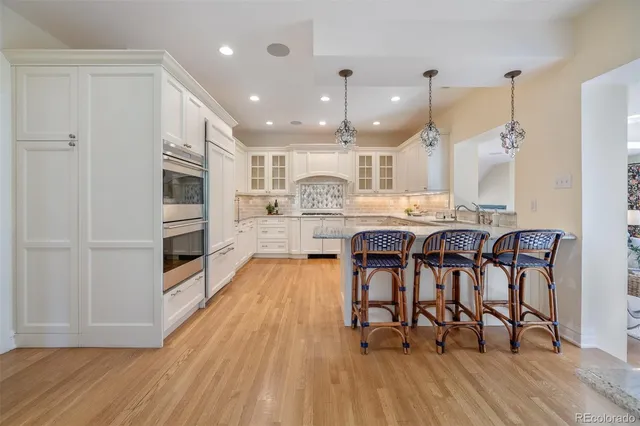 a large kitchen with a table and chairs