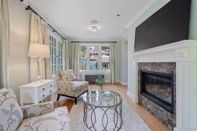a living room with furniture a window and a fireplace