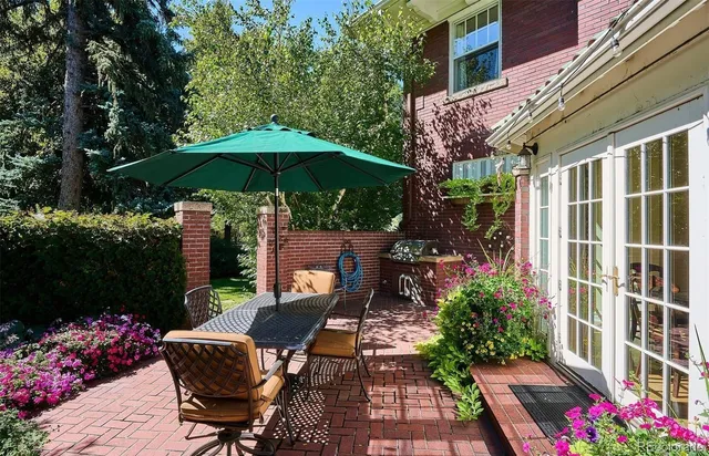 a view of a patio with table and chairs under an umbrella