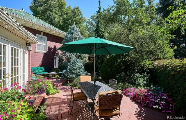 a view of a backyard with plants and a patio