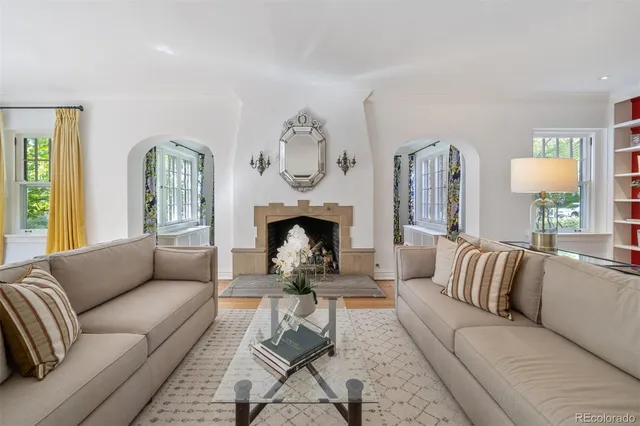a living room with furniture fireplace and window