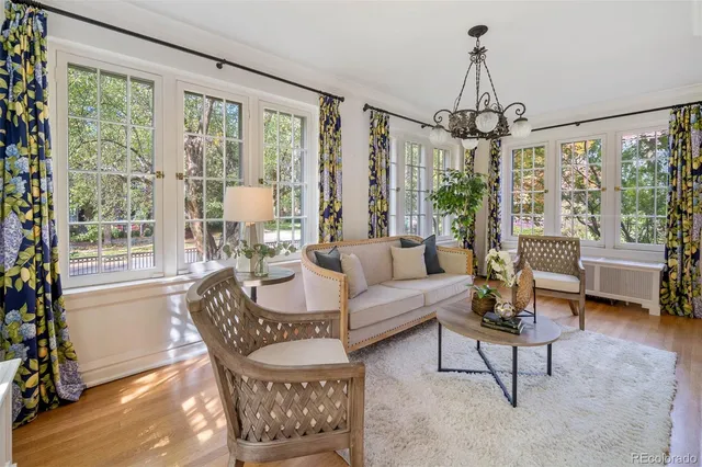 a living room with furniture and a chandelier