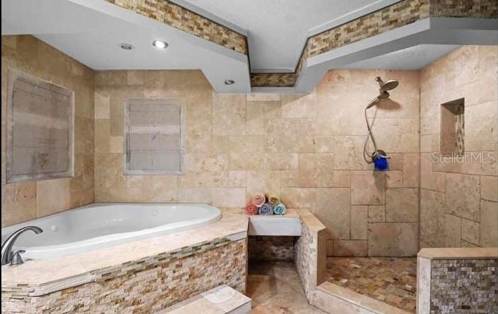 5717 Southwest County Rd Lake Lake Butler, FL 32054 - Photo 13 of 19 a bathroom with a bathtub and a shower