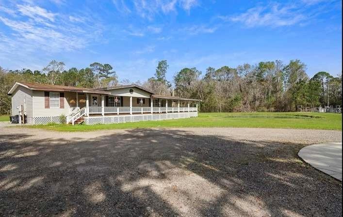 5717 Southwest County Rd Lake Lake Butler, FL 32054 - Photo 2 of 19 a view of a house with a big yard
