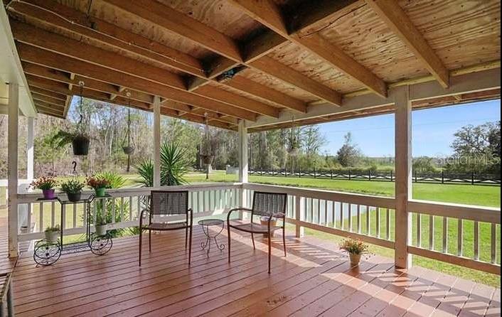 5717 Southwest County Rd Lake Lake Butler, FL 32054 - Photo 5 of 19 a view of a chairs and table on the deck
