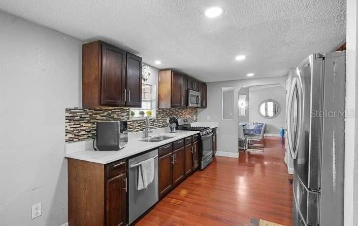 5717 Southwest County Rd Lake Lake Butler, FL 32054 - Photo 8 of 19 a kitchen with stainless steel appliances granite countertop a sink stove and cabinets