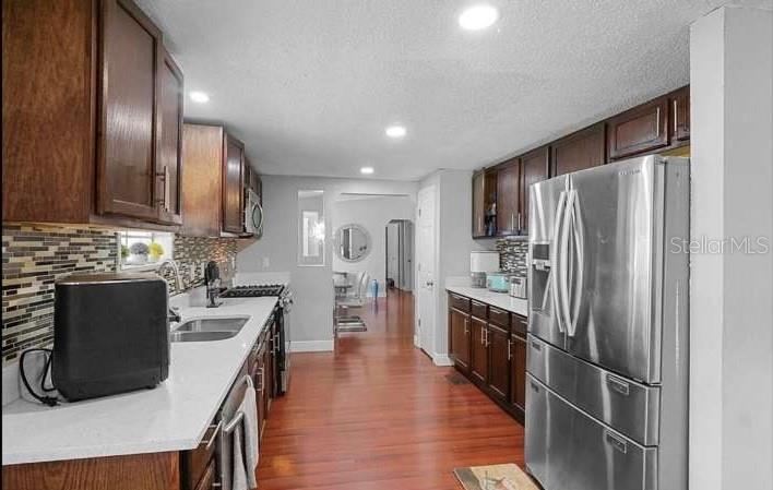 5717 Southwest County Rd Lake Lake Butler, FL 32054 - Photo 10 of 19 a kitchen with stainless steel appliances granite countertop a refrigerator a stove top oven a sink and dishwasher
