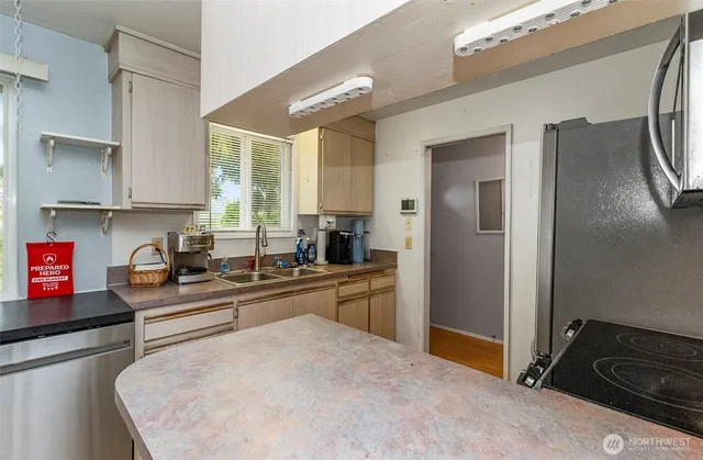 a kitchen with stainless steel appliances granite countertop a refrigerator and a stove top oven