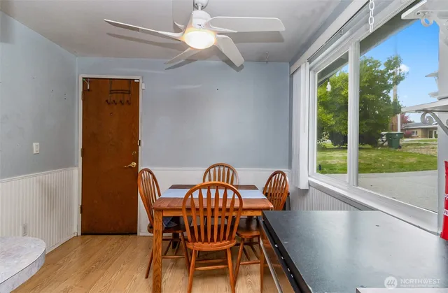 a view of a dining room with furniture wooden floor and chandelier