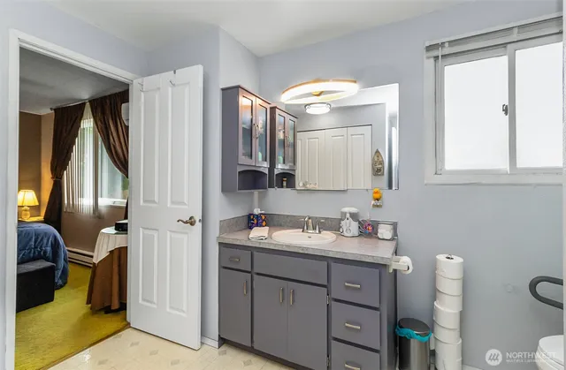a bathroom with a double vanity sink and a mirror