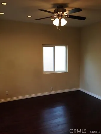 a view of a room with wooden floor and a window