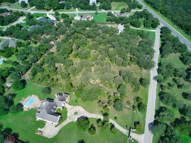 a view of a house with a lush green forest