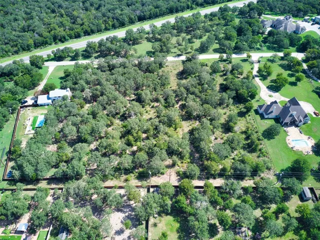 an aerial view of a forest with houses