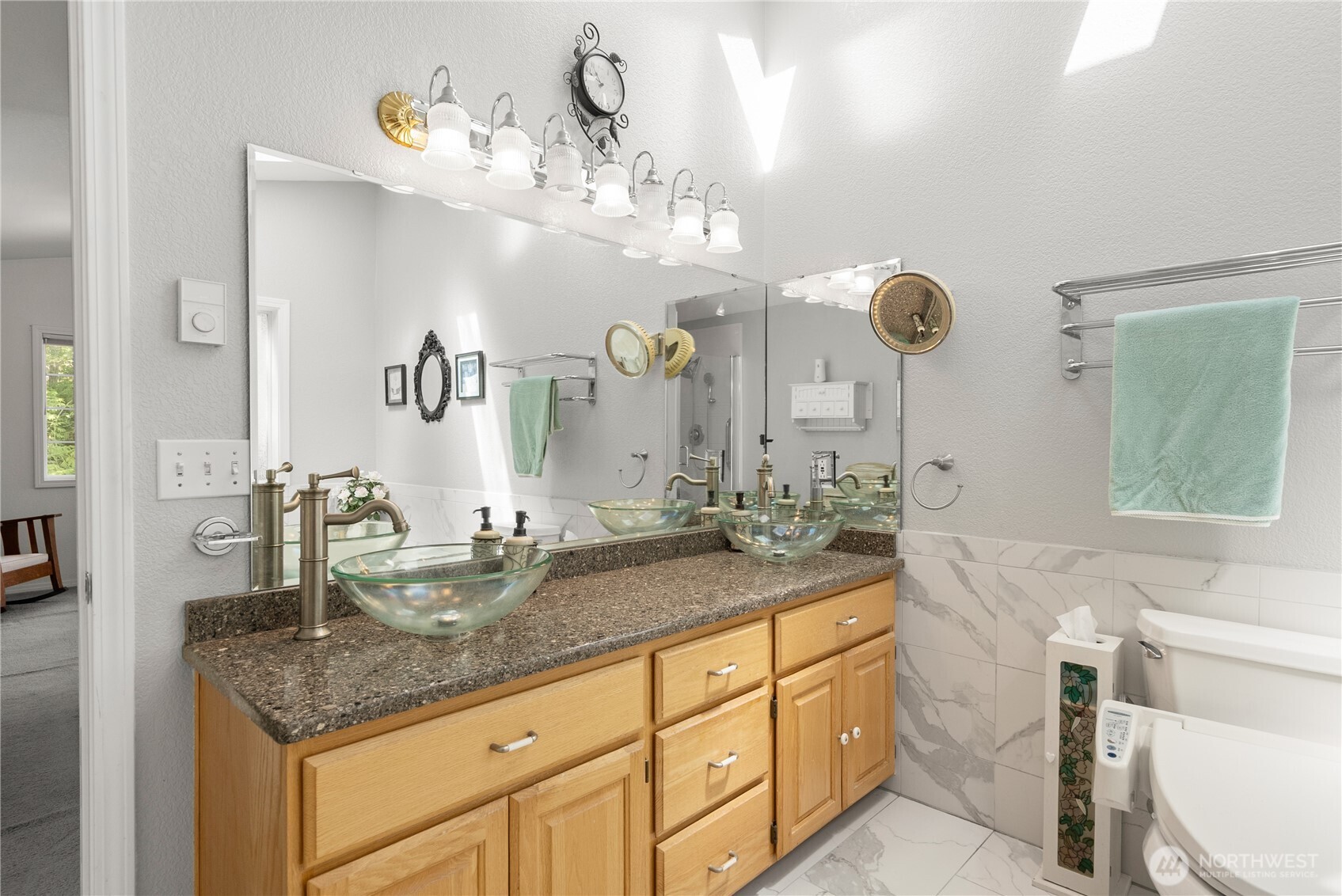 8320 East Grapeview Loop Road Allyn, WA 98524 - Photo 21 of 38 a bathroom with a granite countertop double vanity sink and mirror