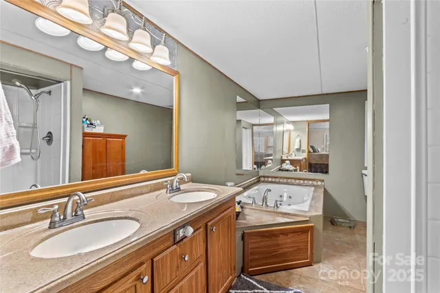 a bathroom with a granite countertop sink a mirror and vanity