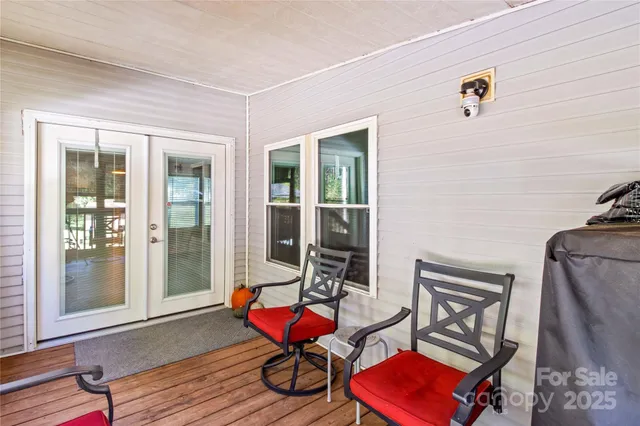 a living room with furniture a wooden floor and next to a window