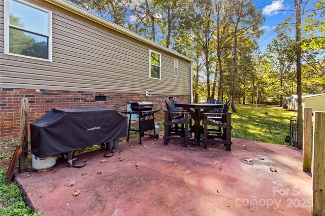 a view of a backyard with sitting area and furniture