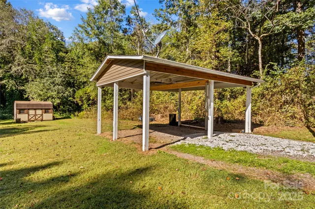 a view of a house with a backyard patio and swimming pool