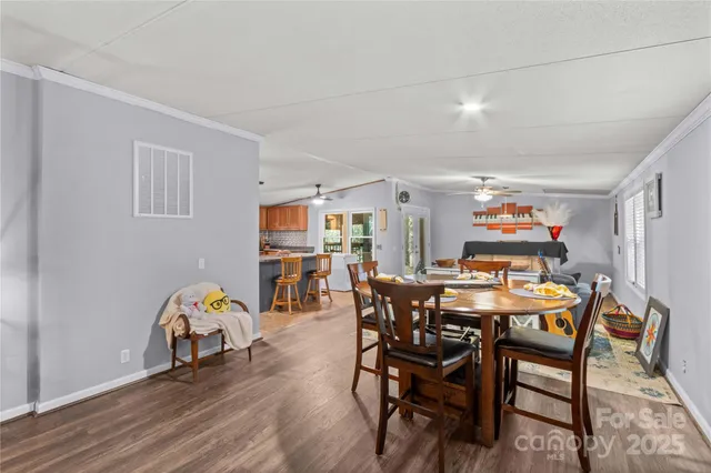 a view of a dining room with furniture and wooden floor