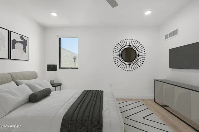 a bedroom with a bed and a television