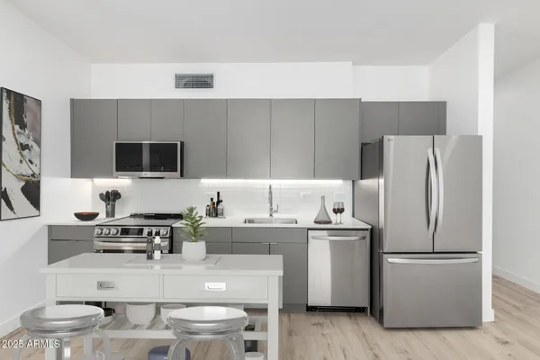 a kitchen with a sink a stove and chairs