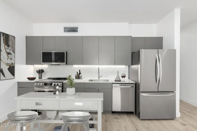 a kitchen with a sink a stove and chairs