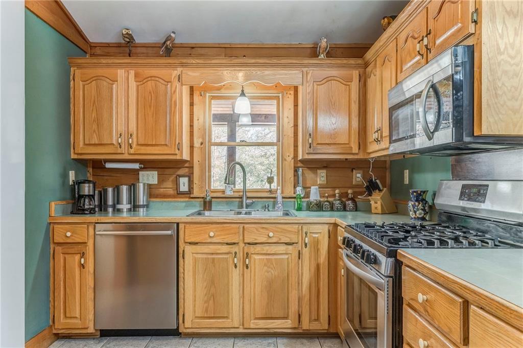 4569 Old Dalton Road Northeast Rome, GA 30165 - Photo 18 of 53 a kitchen with stainless steel appliances granite countertop a stove and a refrigerator