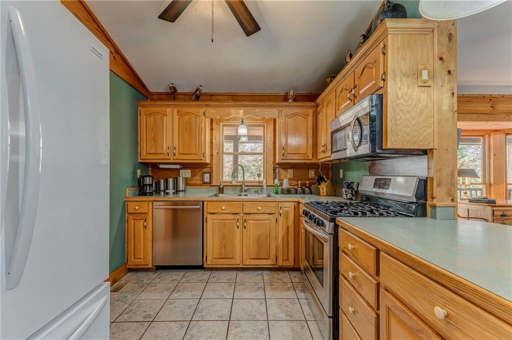 4569 Old Dalton Road Northeast Rome, GA 30165 - Photo 19 of 53 a kitchen with stainless steel appliances granite countertop a sink and cabinets