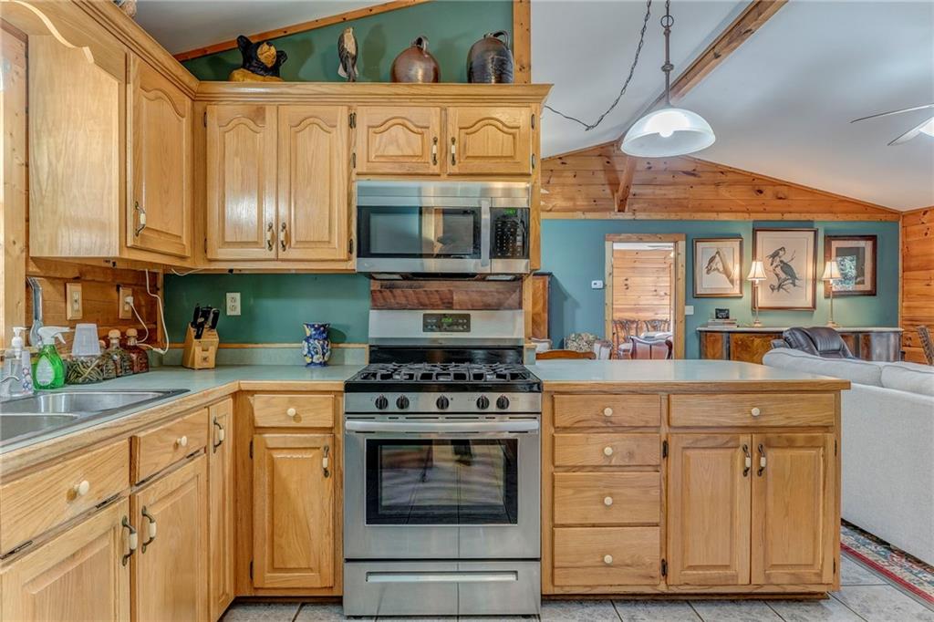 4569 Old Dalton Road Northeast Rome, GA 30165 - Photo 20 of 53 a kitchen with stainless steel appliances granite countertop a stove a sink and a microwave