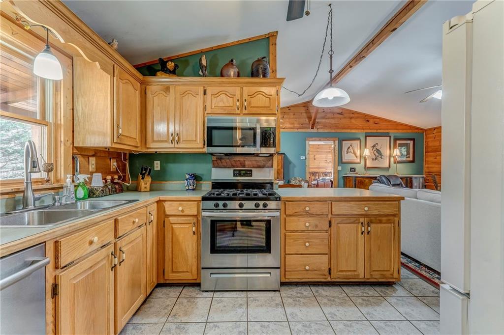 4569 Old Dalton Road Northeast Rome, GA 30165 - Photo 21 of 53 a kitchen with stainless steel appliances granite countertop a stove and cabinets