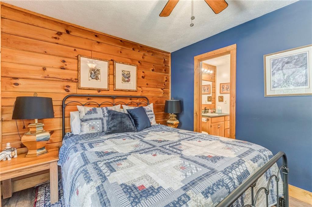 4569 Old Dalton Road Northeast Rome, GA 30165 - Photo 23 of 53 a bedroom with a bed and a lamp on the dresser