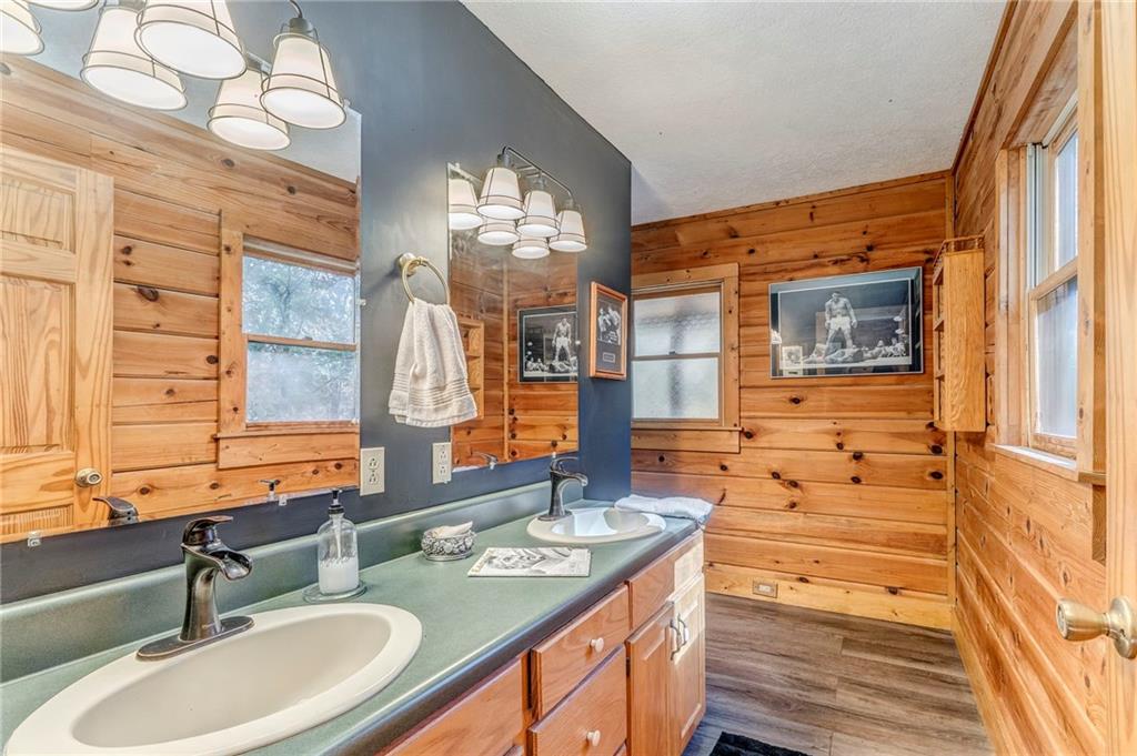 4569 Old Dalton Road Northeast Rome, GA 30165 - Photo 37 of 53 a bathroom with double vanity sinks a mirror and a shower