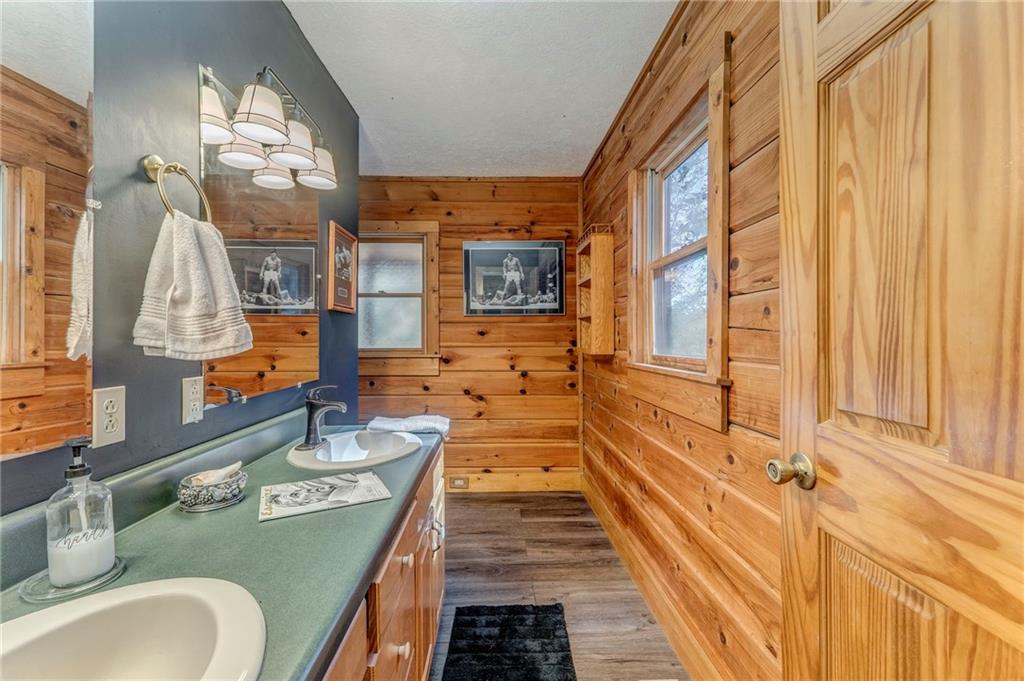4569 Old Dalton Road Northeast Rome, GA 30165 - Photo 38 of 53 a bathroom with a granite countertop double vanity sink a mirror and a shower
