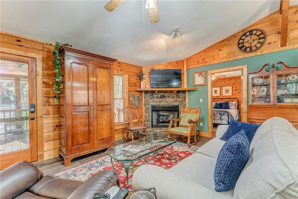4569 Old Dalton Road Northeast Rome, GA 30165 - Photo 6 of 53 a living room with furniture a fireplace and a painting on the wall