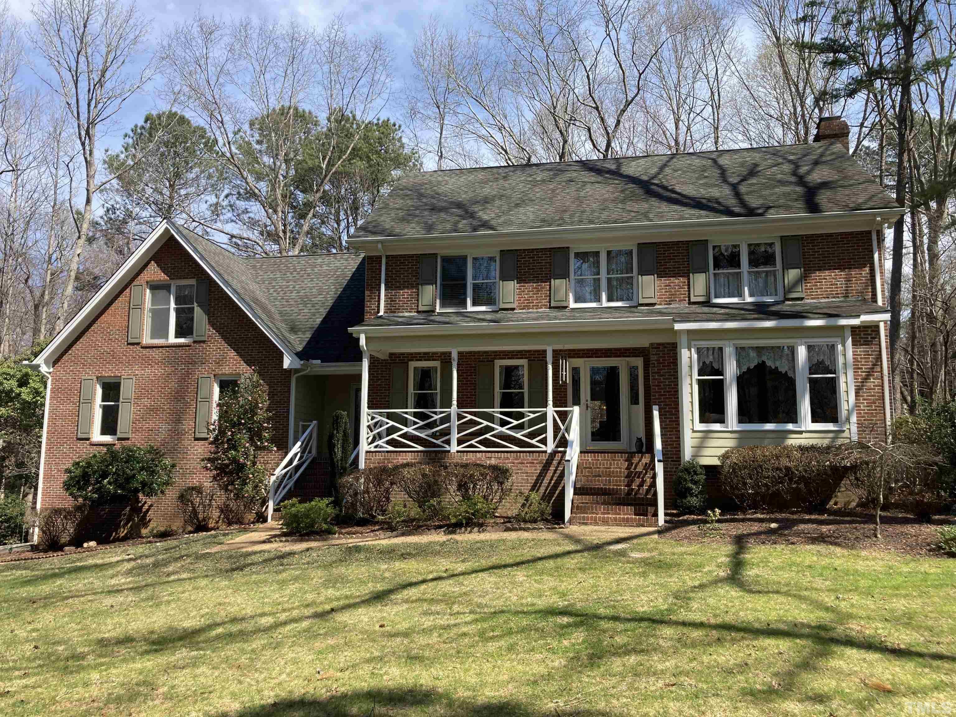 11613 Appaloosa Street West Raleigh, NC 27613 - Photo 1 of 6 a front view of a house with a yard glass top table and chairs