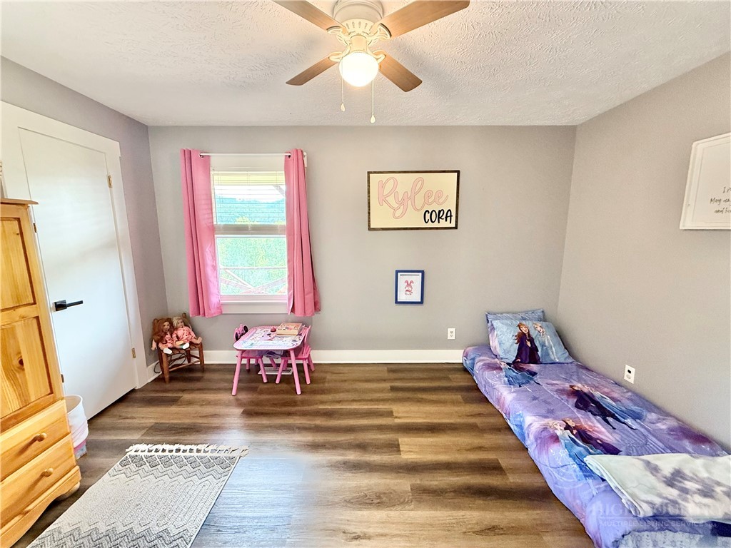 1315 Irwin Grocery Road Laurel Springs, NC 28644 - Photo 15 of 22 a bedroom with a bed and wooden floor