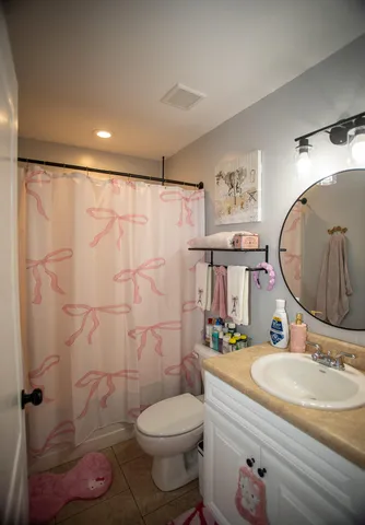 a bathroom with a sink toilet a mirror and shower