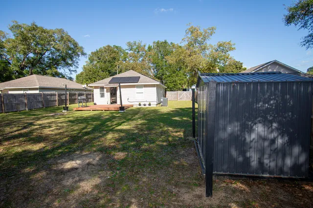 a view of a house with a yard and sitting area