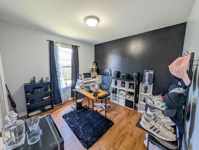 a view of a house with a yard and a large tree