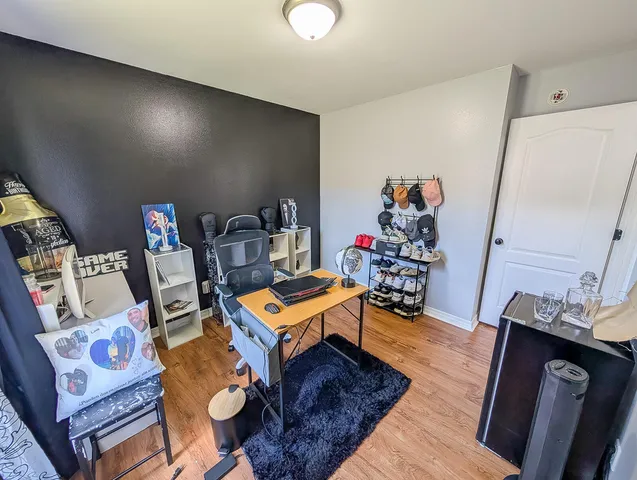 a bed room with a bed mirror and a chandelier