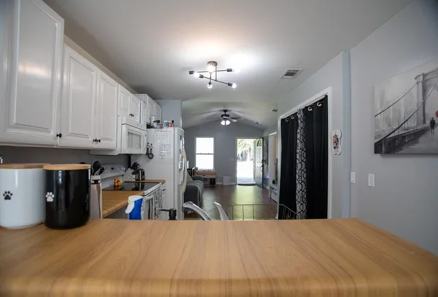 a large kitchen with cabinets and stainless steel appliances