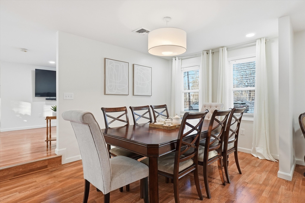 186 Mohawk Trail Haverhill, MA 01832 - Photo 12 of 42 a view of a a dining room with furniture window and wooden floor