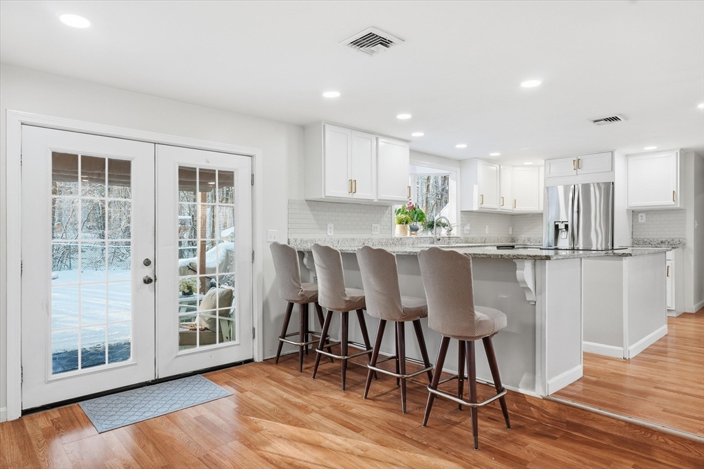 186 Mohawk Trail Haverhill, MA 01832 - Photo 14 of 42 a kitchen with stainless steel appliances granite countertop a table chairs refrigerator sink and cabinets