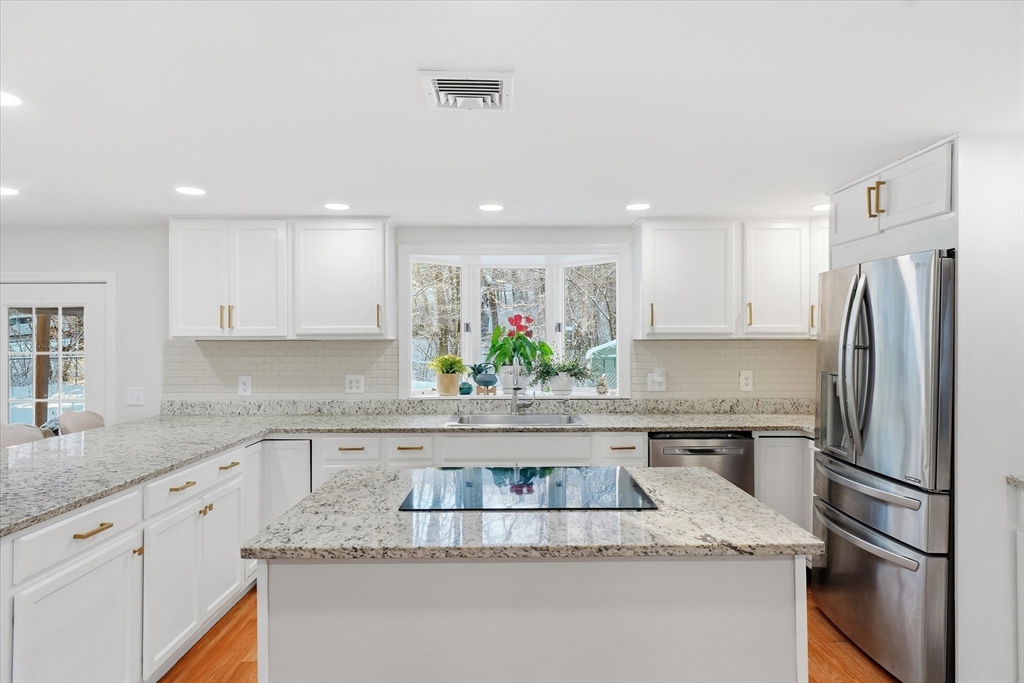 186 Mohawk Trail Haverhill, MA 01832 - Photo 17 of 42 a kitchen with stainless steel appliances granite countertop a sink and a refrigerator