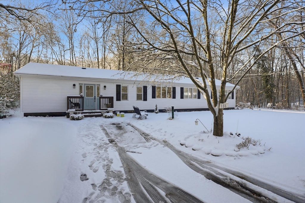 186 Mohawk Trail Haverhill, MA 01832 - Photo 2 of 42 a view of house with a yard covered in snow