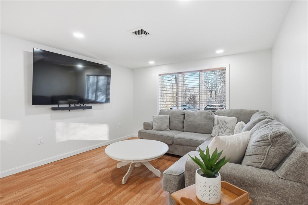 186 Mohawk Trail Haverhill, MA 01832 - Photo 21 of 42 a living room with furniture and a flat screen tv