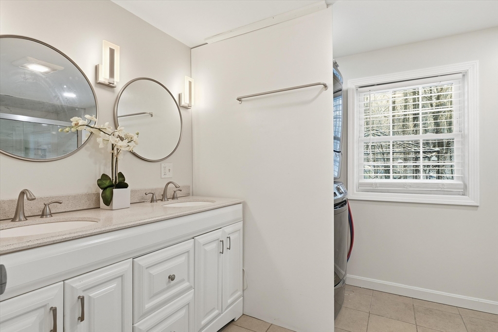 186 Mohawk Trail Haverhill, MA 01832 - Photo 24 of 42 a bathroom with a double vanity sink and a mirror